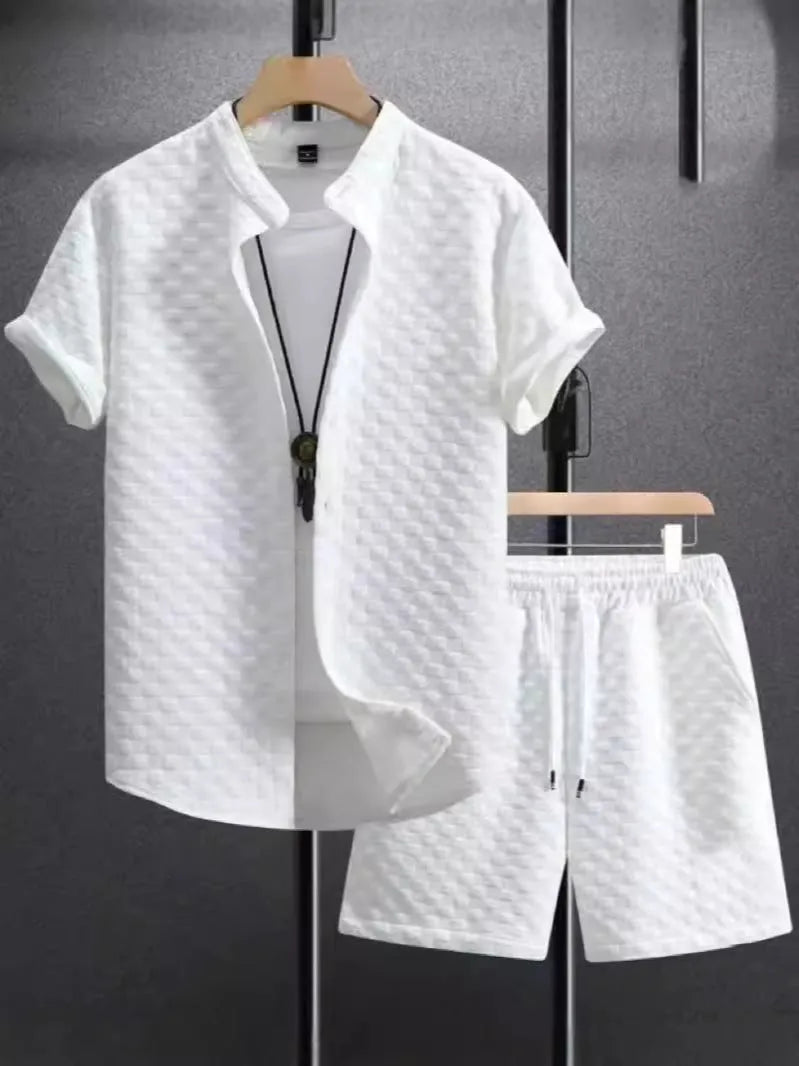 Man wearing a black and white jacquard patterned short sleeve suit shirt with matching formal shorts.