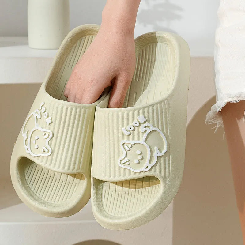 Women's green cat-themed platform slippers with non-slip EVA sole on a wooden floor.