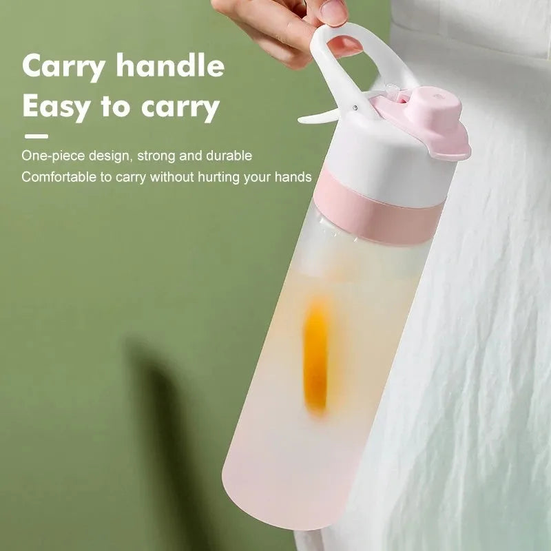 White plastic spray water bottle with handle strap and leakproof lid on a gym bag.