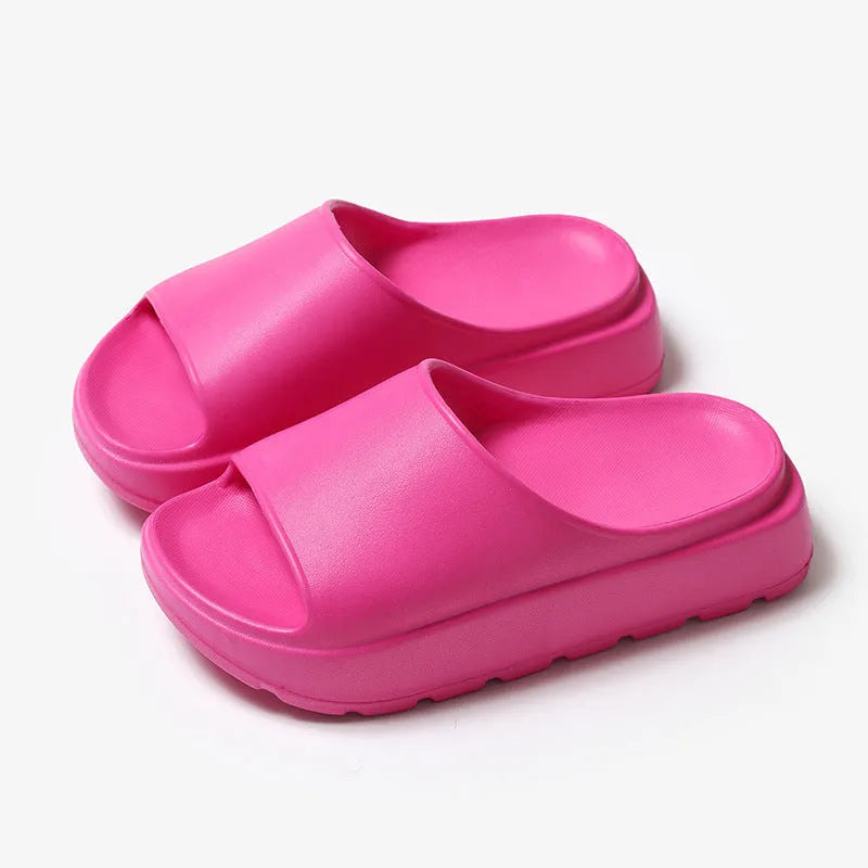 Women's beige fish mouth style slippers with a thick EVA sole on a wooden floor.