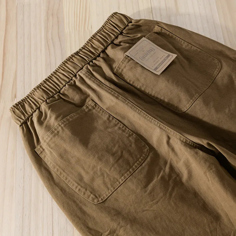 Man wearing Amekaji-style casual overalls with ankle banding in Army Green colour.