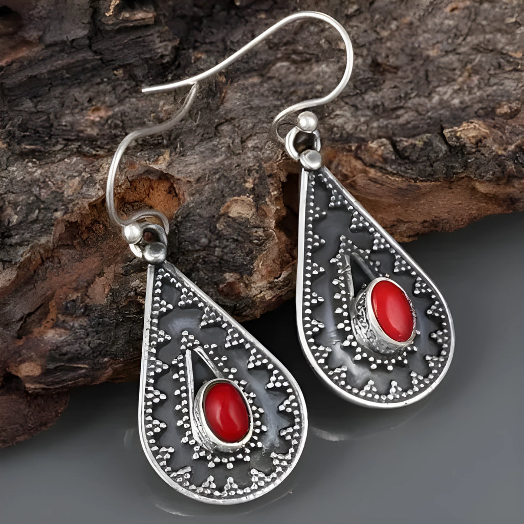 Silver drop earrings with a red pine gemstone in a retro zinc alloy setting.