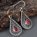 Silver drop earrings with a red pine gemstone in a retro zinc alloy setting.