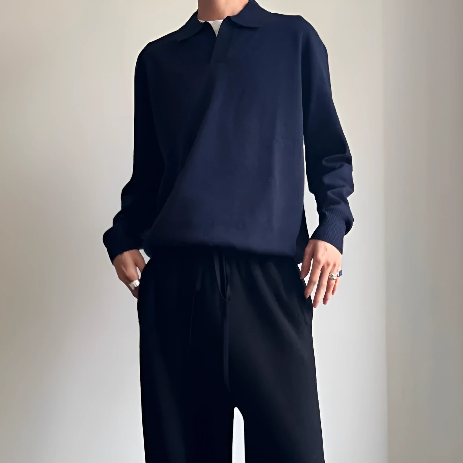 Man's pure wool polo sweater with lapel collar in loose fit, shown in milky white.