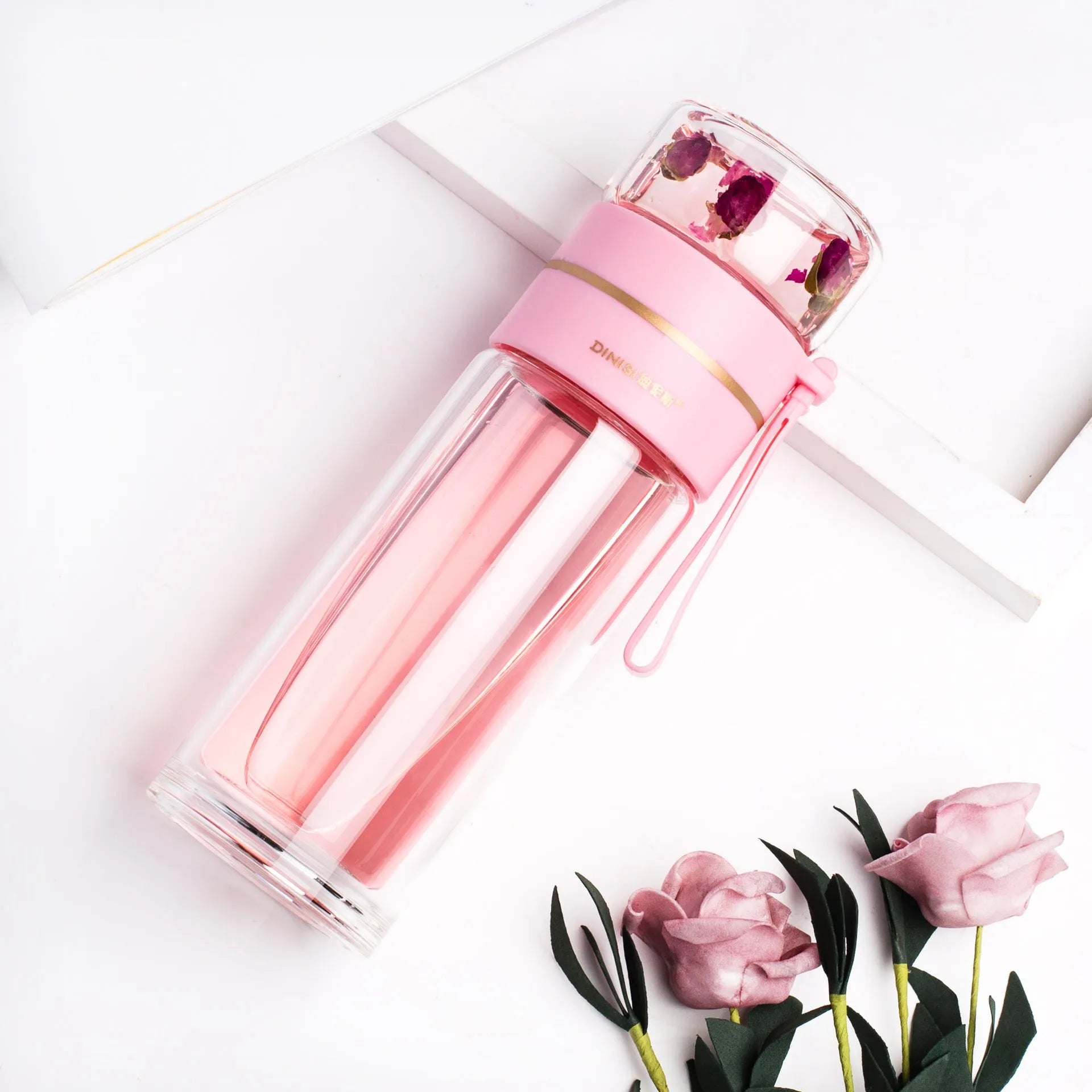 Glass water bottle with tea infuser filter showing double wall construction and portable rope