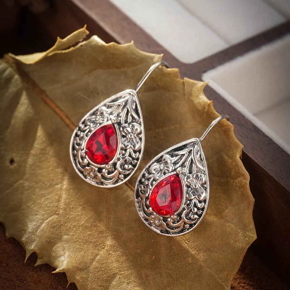Retro bohemian carved ruby drop earrings for women in red alloy finish