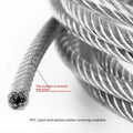 Close-up of a multi-strand 304 stainless steel anti-theft security cable coiled on a dark surface.