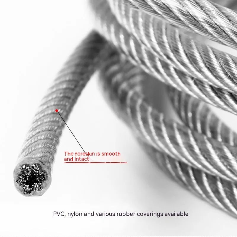 Close-up of a multi-strand 304 stainless steel anti-theft security cable coiled on a dark surface.