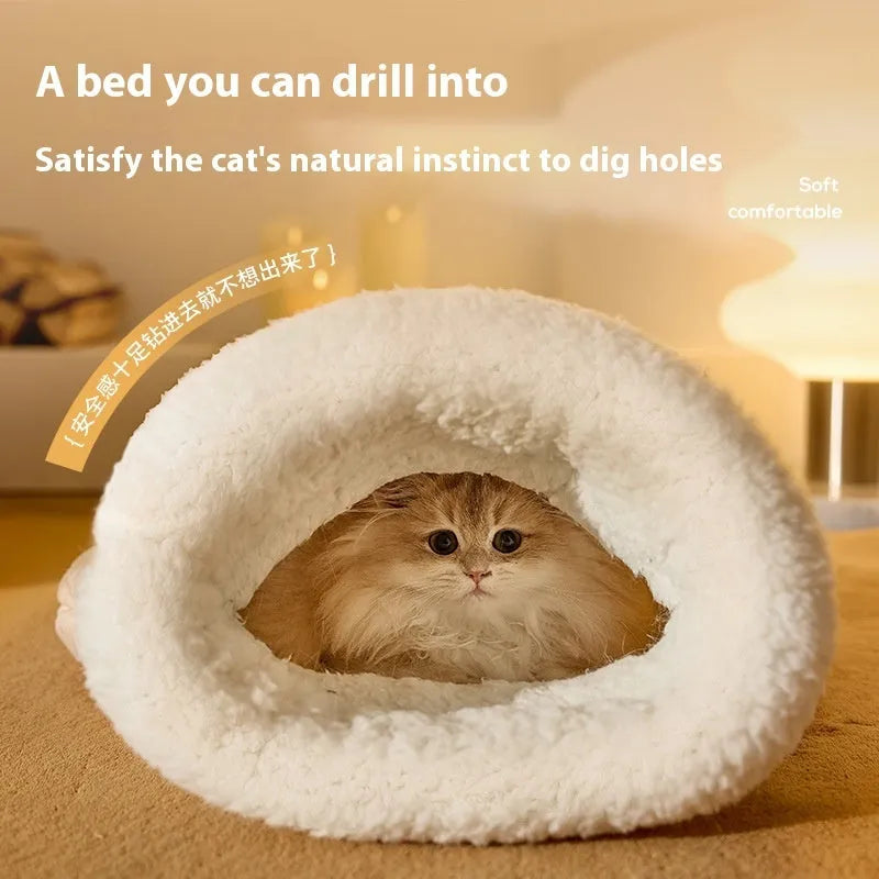 Fleece cat sleeping bag nest in light brown colour with a 3D entrance, shown on a wooden floor.