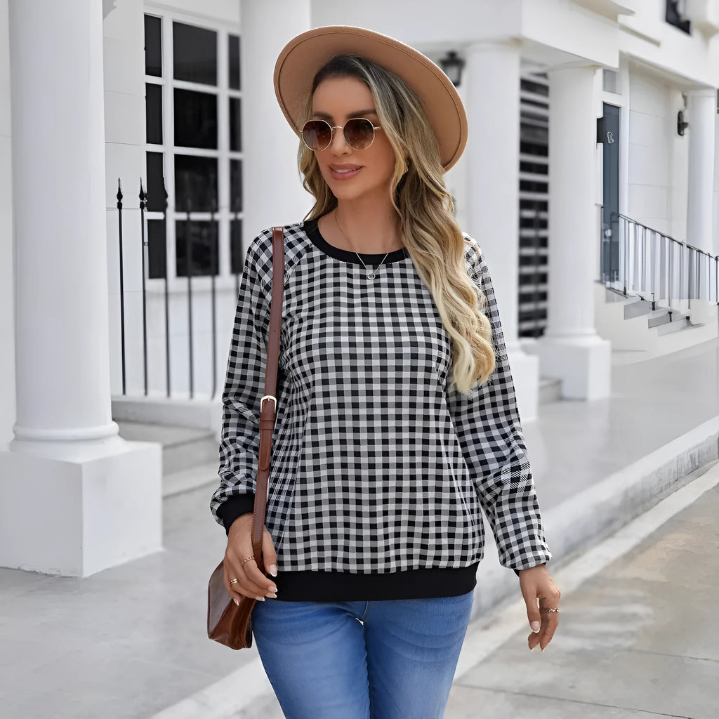 Black polyester pullover sweater with a plaid and printed stripe pattern, long sleeves.