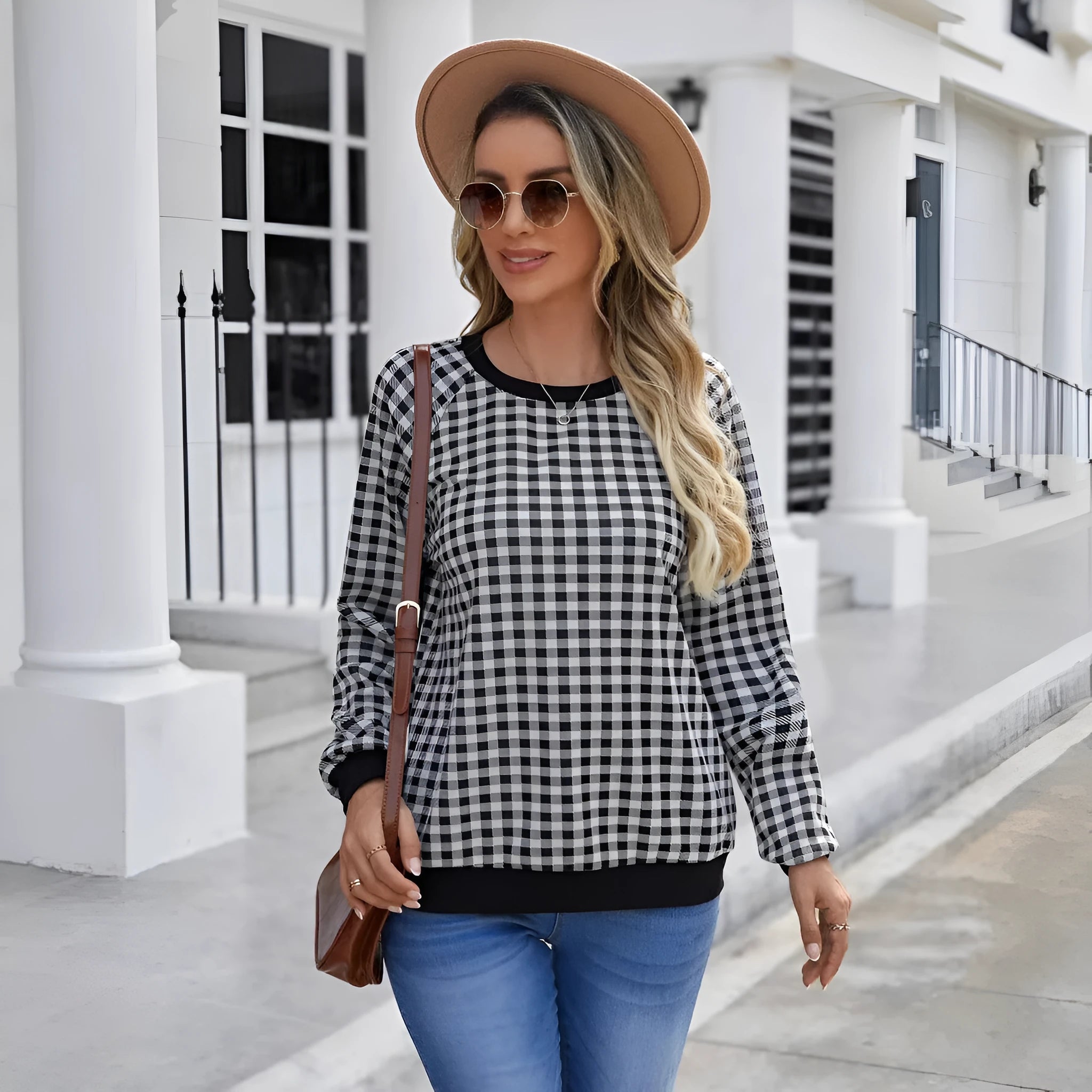 Black polyester pullover sweater with a plaid and printed stripe pattern, long sleeves.
