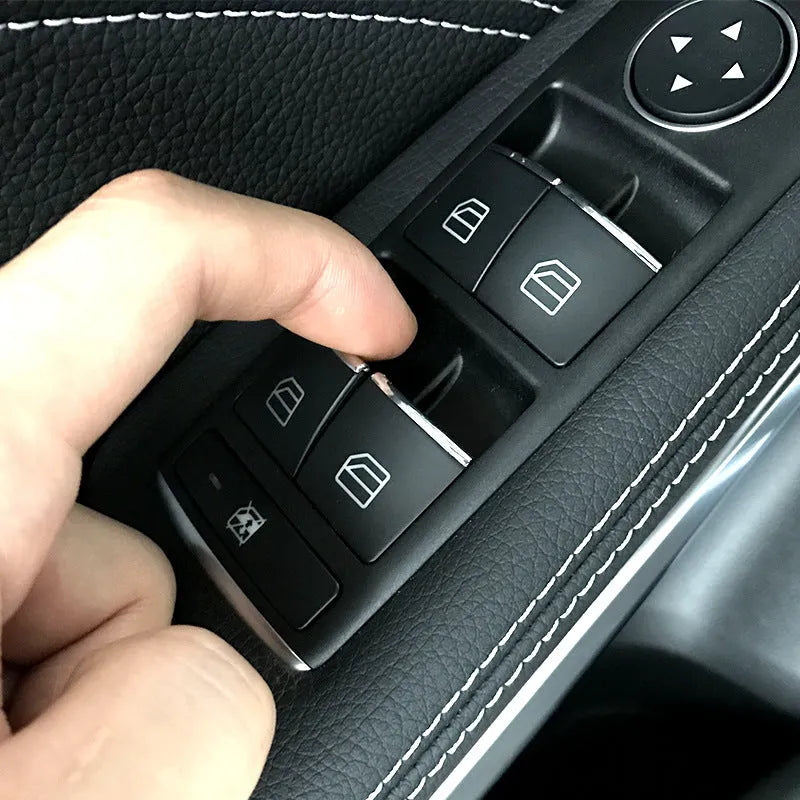 Black ABS plastic decorative sticker for car window lift button on door panel.