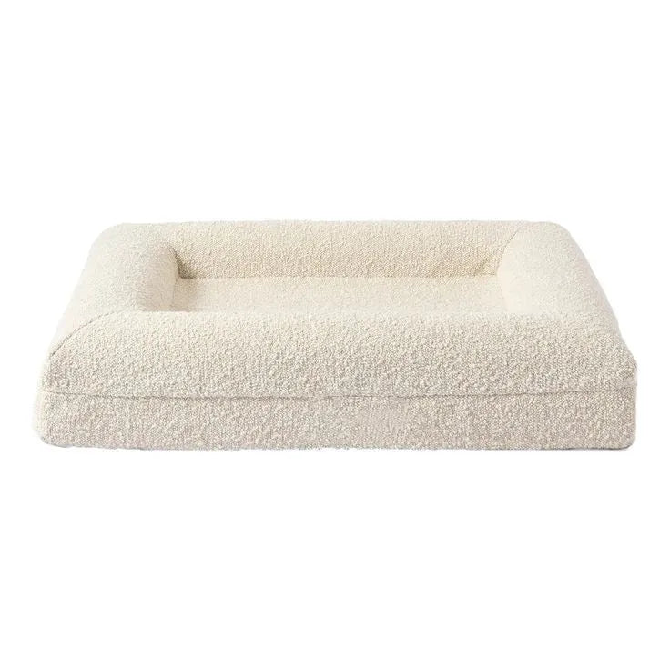 Beige rectangular cloth dog sofa bed for medium-sized dogs on a wooden floor.