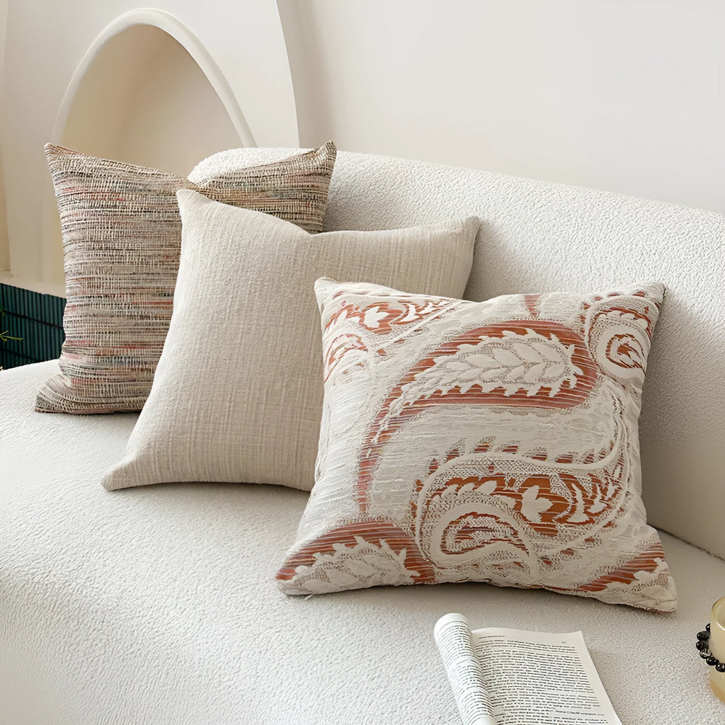 American-style jacquard paisley pattern sofa cushion cover in an amber colour on a grey sofa.