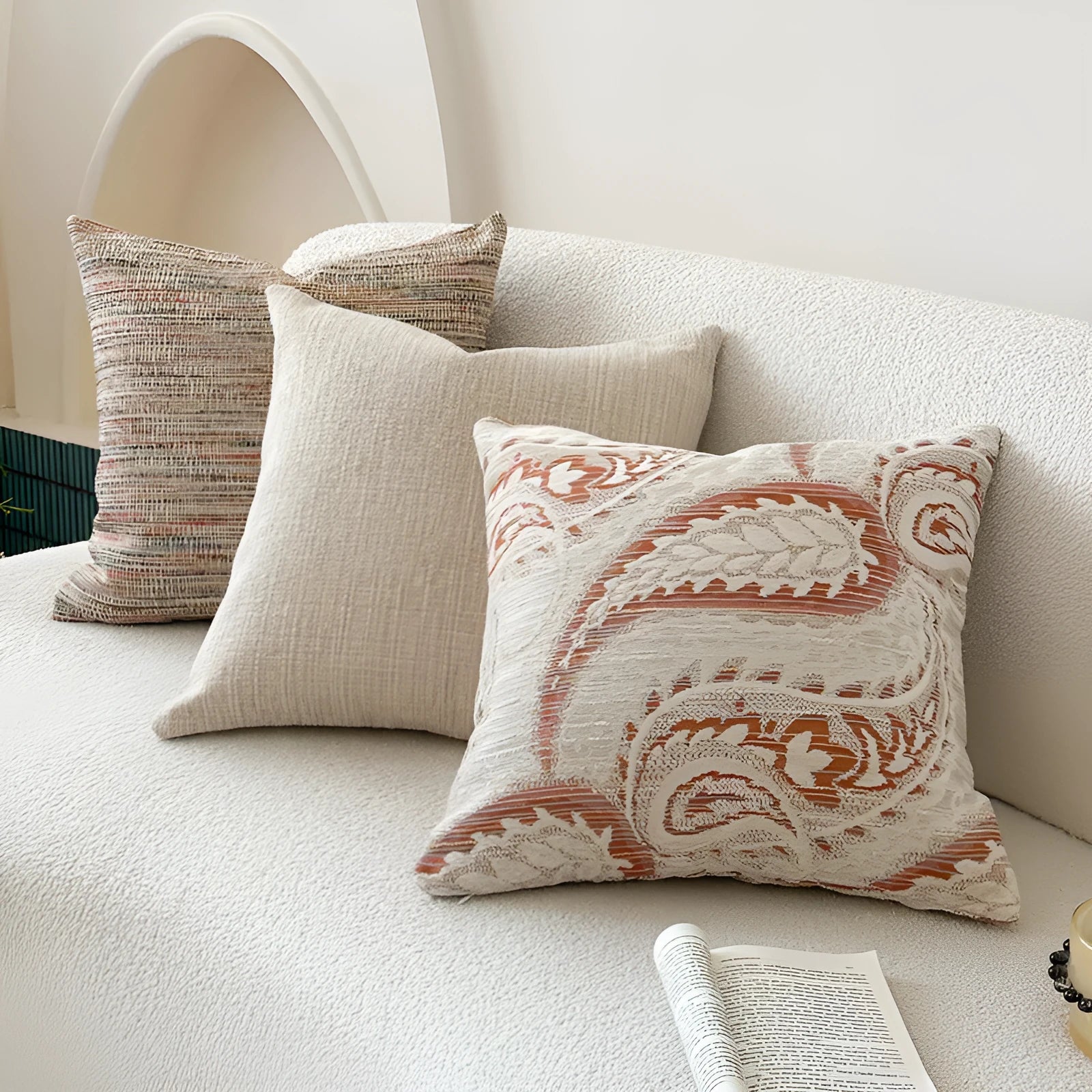 American-style jacquard paisley pattern sofa cushion cover in an amber colour on a grey sofa.