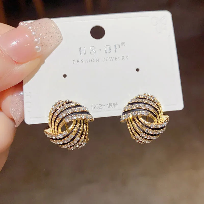 Gold plated rhinestone stud earrings with geometric ring shape and super-flash finish