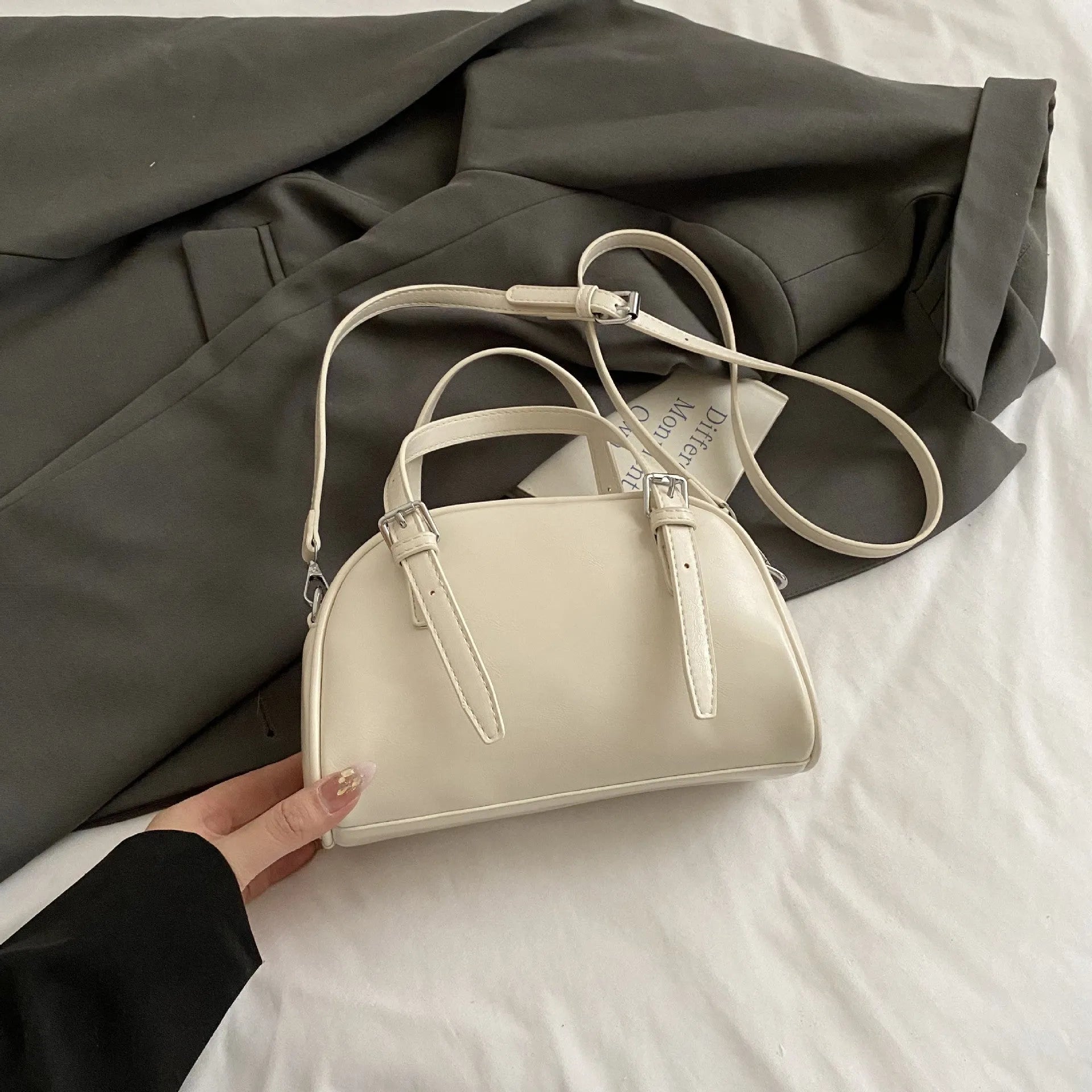 Women's square shoulder bag in PU leather with soft shell shape and optional ribbon pendant