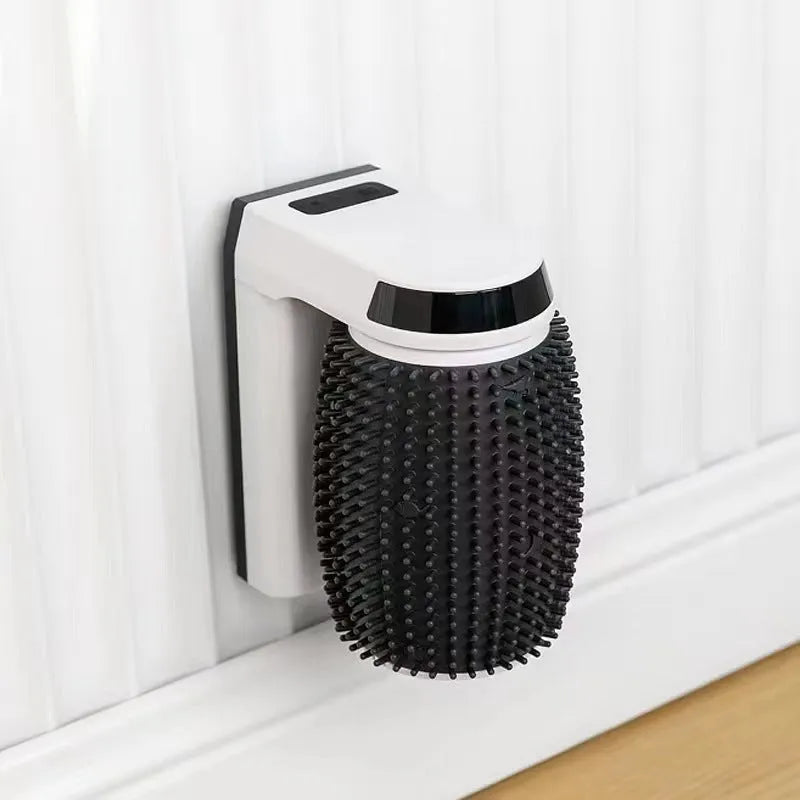 White automatic cat self-groomer with silicone bristles mounted in a corner.