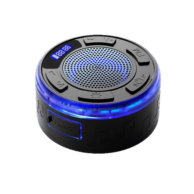 Waterproof Bluetooth speaker with large suction cup in black, mounted on bathroom tile