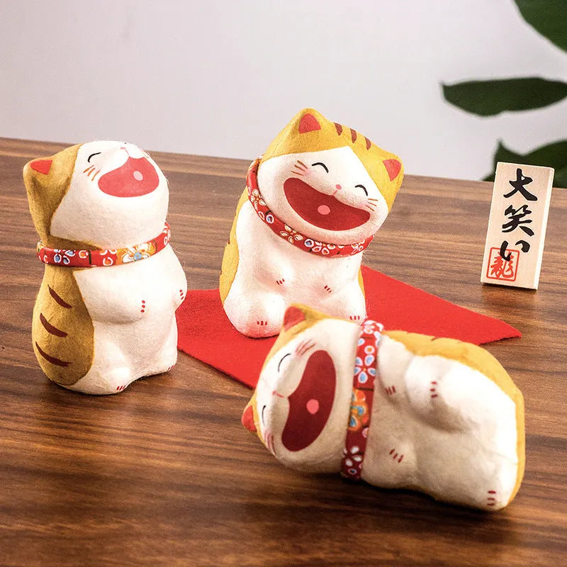 Handmade Japanese paper lucky cat figurine in Sanmao cat style, sitting on a car dashboard