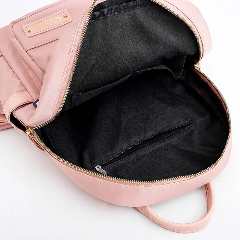 Black casual nylon backpack with double shoulder straps and external pocket.