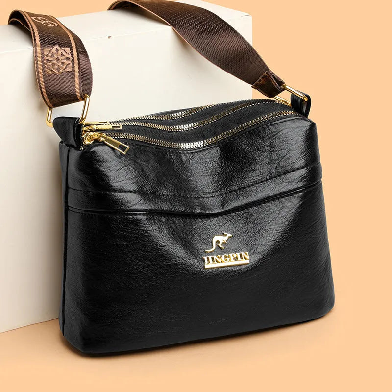Cross body messenger bag in horizontal square shape with multiple compartments and sandwich pocket construction