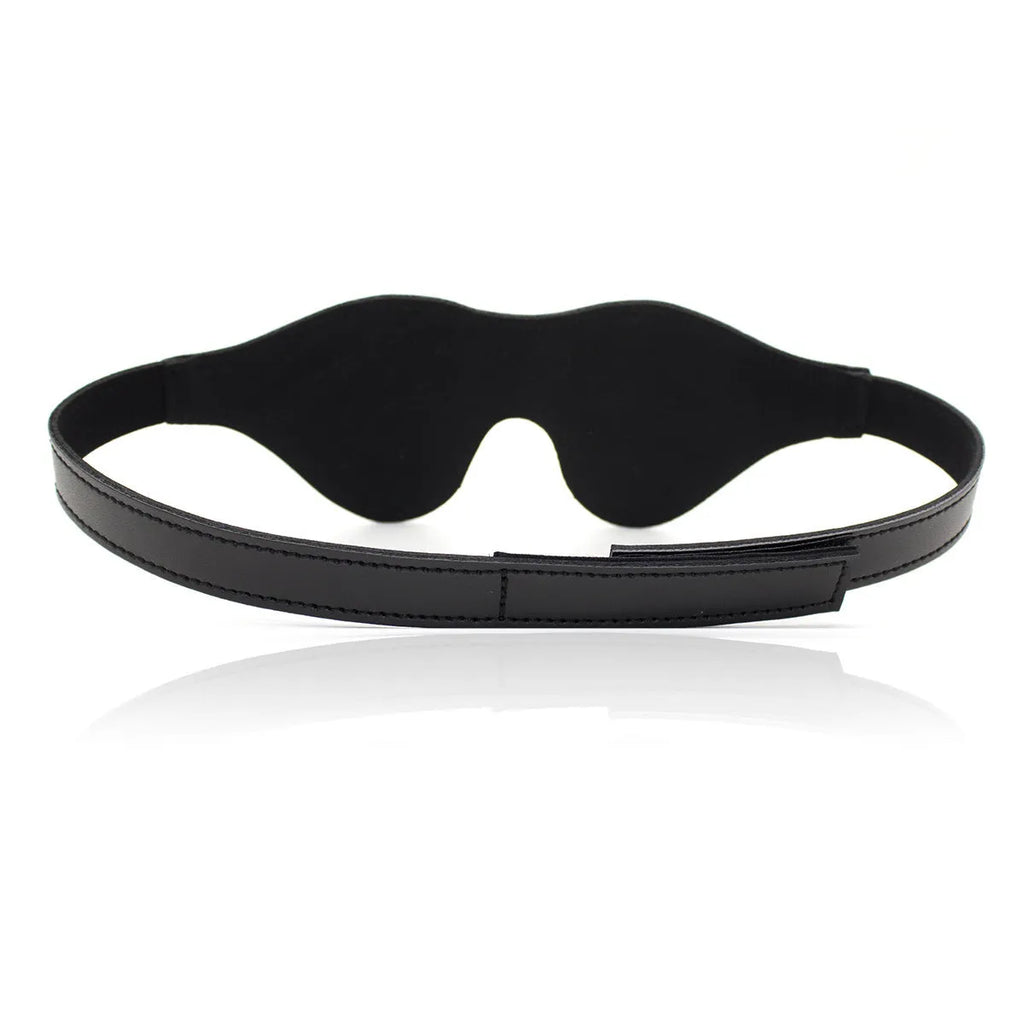 Women's black leather eye mask with 3D shape, Velcro strap, and metal rivet details.