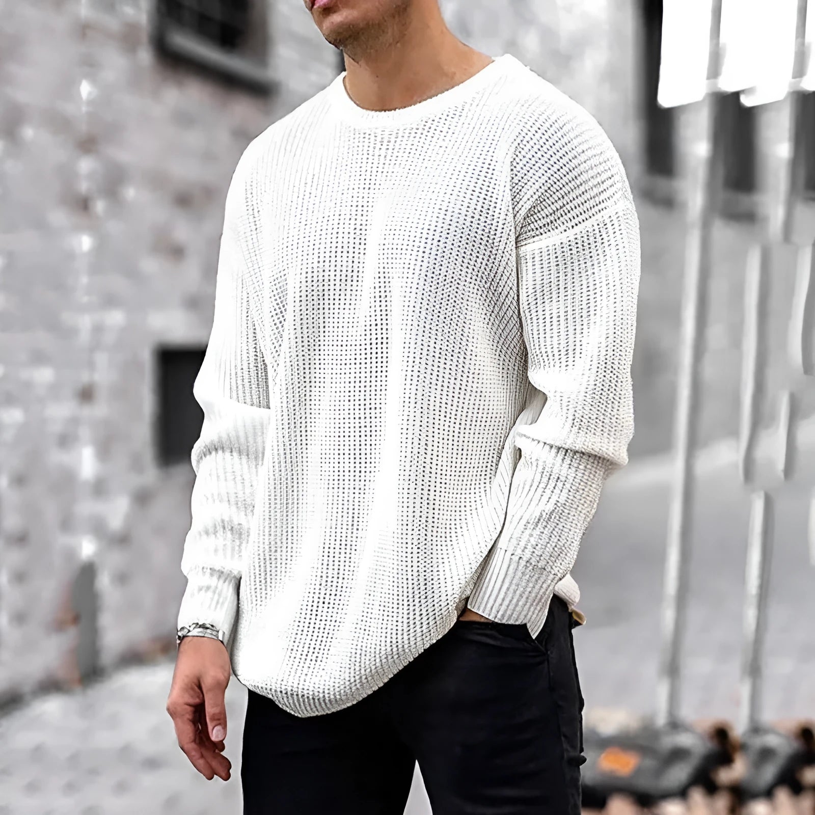 Men's solid colour round neck long sleeve acrylic sweater in black, folded flat on a white background