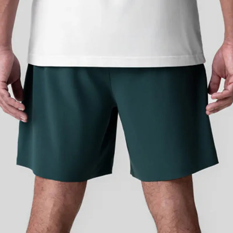 Men's grey seamless sports shorts with knee length and straight cut design for athletic activities
