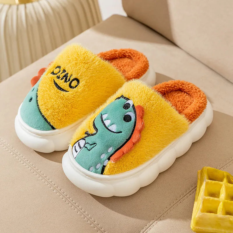 A pair of plush cotton couple slippers with dinosaur print, shown in coffee colour.