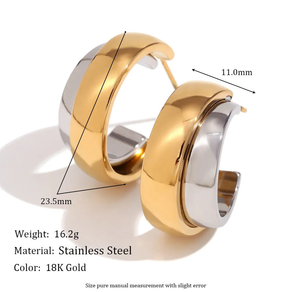 Geometric gold-tone stainless steel jewellery set showing earrings, a bracelet, and a necklace with circular designs on a grey background.