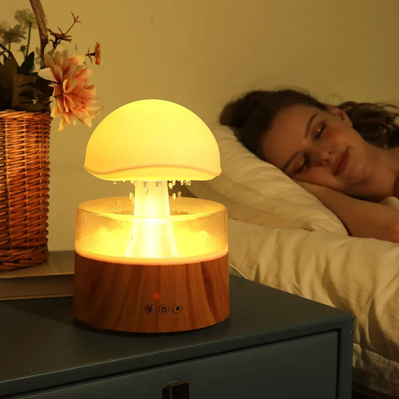 White cloud-shaped humidifier and aroma diffuser with falling water droplets and coloured lights
