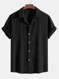 A man wearing a loose-fit, short-sleeve cardigan in a solid colour, suitable for summer.
