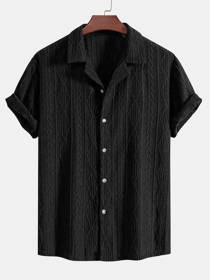 A man wearing a loose-fit, short-sleeve cardigan in a solid colour, suitable for summer.