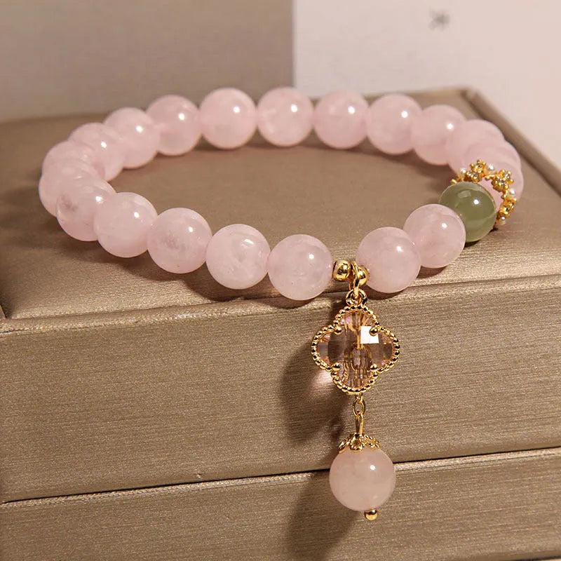 Pink crystal bracelet for women with a four-leaf clover pendant, alloy inlay, and rhinestones.
