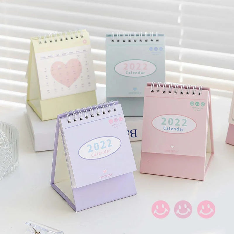 Cream coil bound desk calendar with paper pages, 100mm x 100mm for small desk use