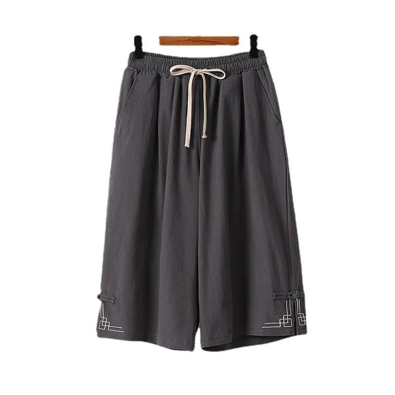 Linen wide leg leisure shorts in apricot colour showing elastic mid waistband and embroidery detail