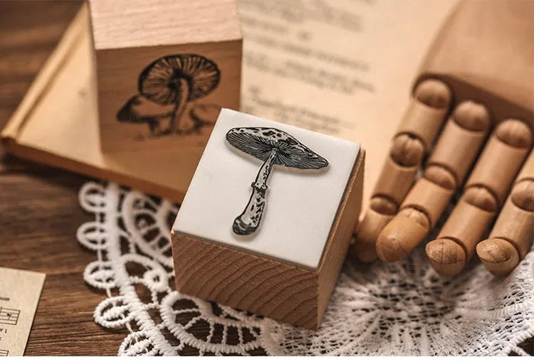 Mr Paper Seal Suit wooden stamp set showing seven stamps in either stars and moon or botanical designs on a craft table.