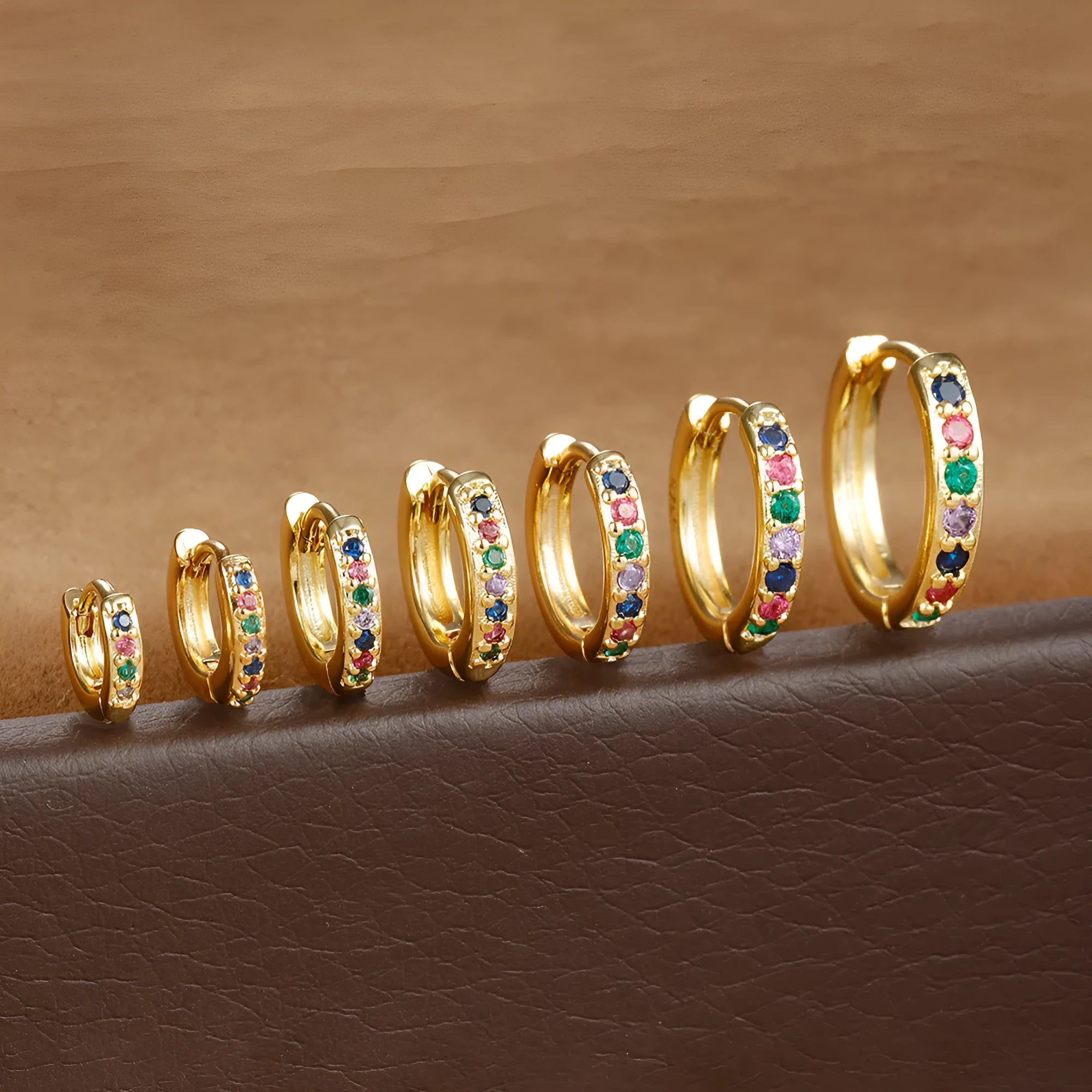 A pair of round geometric circle zircon stud earrings on a plain background, showing gold, rose gold, and silver colour options.