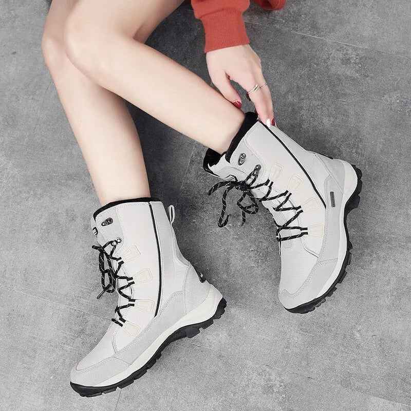 Women's black genuine leather mid-calf snow boots with a round toe and rubber sole.
