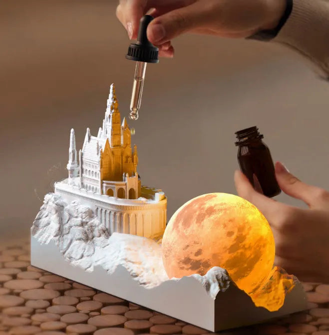 Mountain-shaped aromatherapy night light with touch control, LED lamp, essential oil and card gift set on a desk