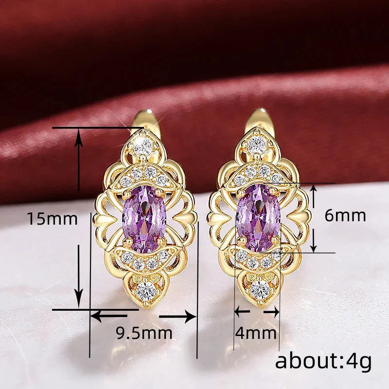 Gold copper flower earrings with hollow design and zircon stones on white background