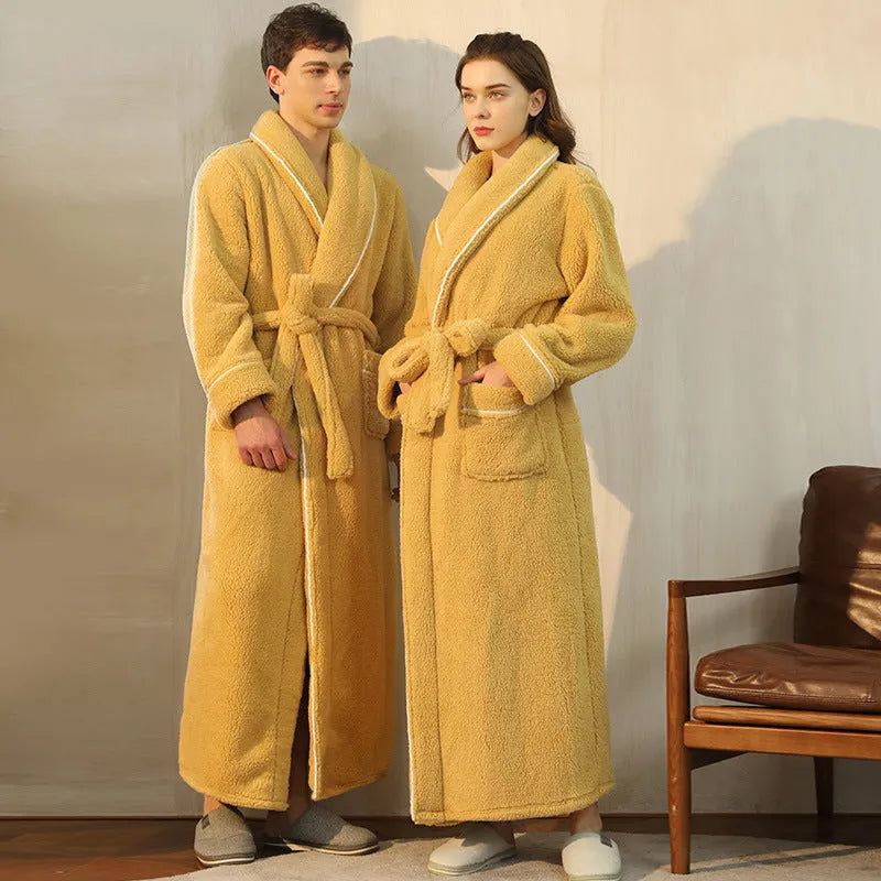 Man and woman wearing matching thick navy blue flannel bathrobes, showcasing the couple's winter loungewear.