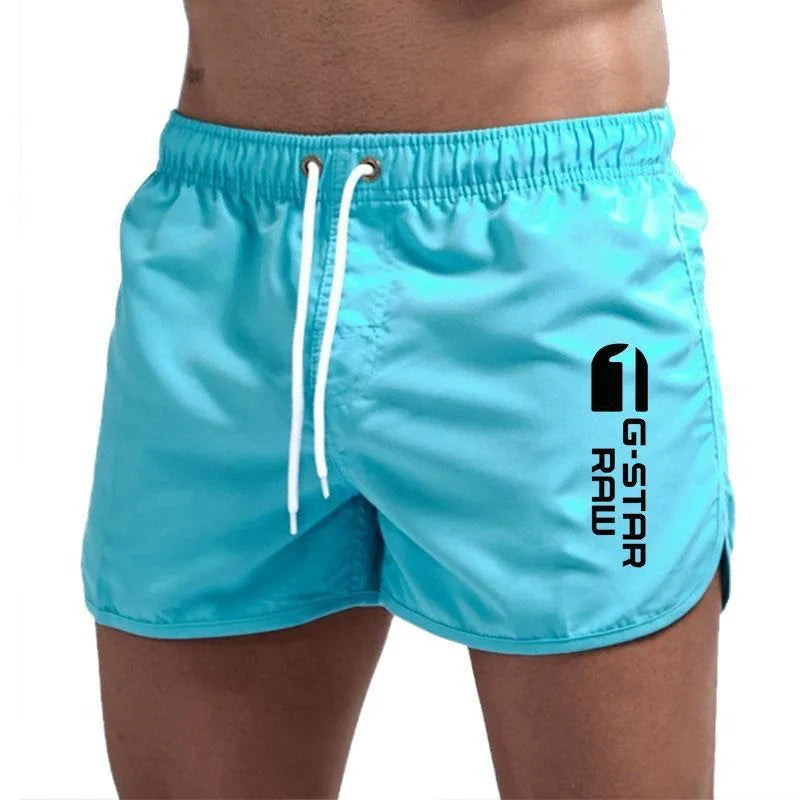 Man wearing thin polyester sports shorts with an elastic waistband in a bright colour like fluorescent green.