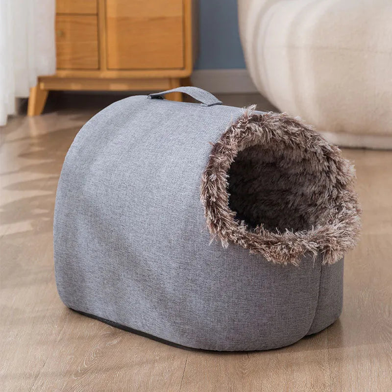 Grey fleece-lined closed cat sleeping bag bed showing enclosed nest design for winter warmth.