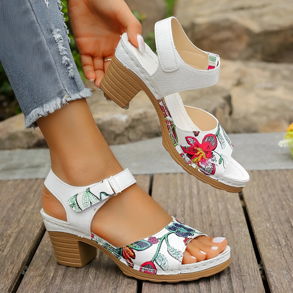 White women's high heel sandals with a Velcro strap buckle on a casual rubber sole.