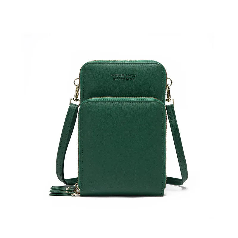 Green crossbody bag with tri-fold pockets and zipper closure on white background