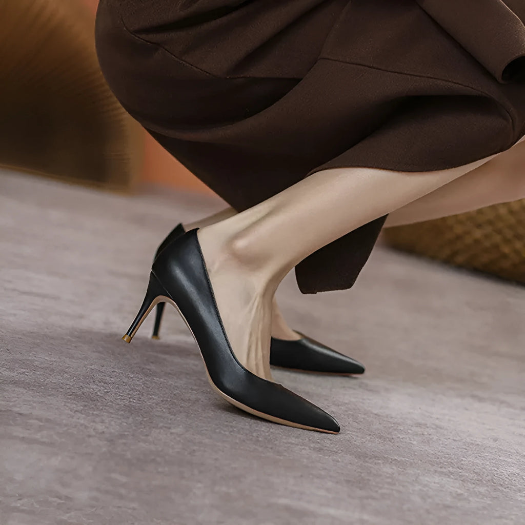 Black pointed-toe stiletto high heel pump shoes for wide feet on a plain background.