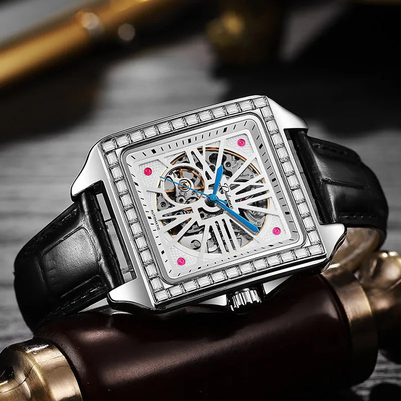 Men's square automatic watch with diamond studs on a black steel strap.