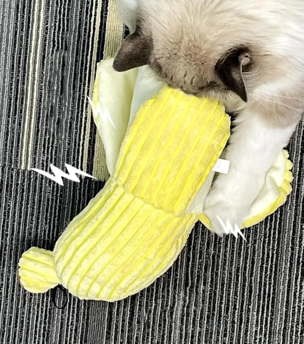Yellow banana-shaped cat toy with textured surface measuring 13 inches long